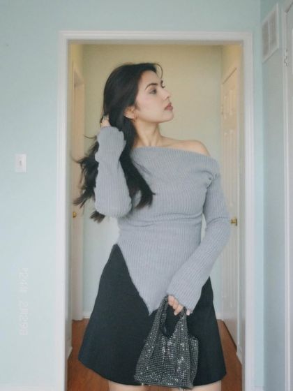 A posed shot in the grey asymmetrical top, looking to the side.