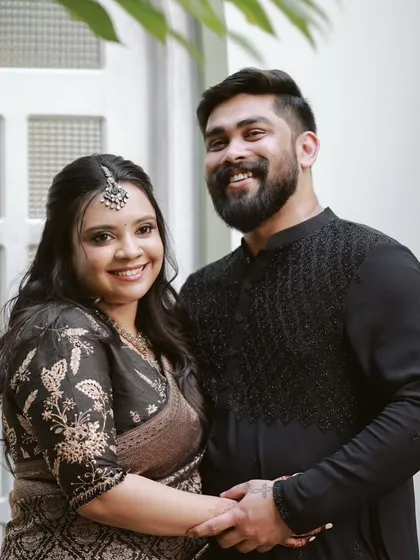 A happy couple. The client's black floral embroidered blouse is a perfect match for her traditional Banarasi saree.
