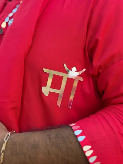 A close-up of my custom 'Maa' brooch. I often add personal touches to my outfits that hold special meaning, like this tribute to my mother.