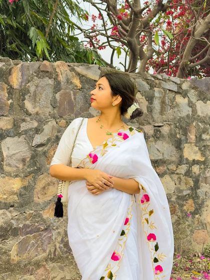 A side profile in the white mul cotton saree. The simplicity of the white fabric allows the colorful floral embroidery to really pop.