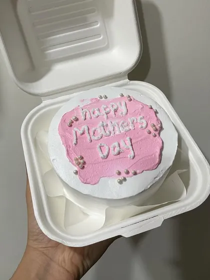 A simple and sweet pink bento cake to celebrate Mother's Day, decorated with edible pearls.