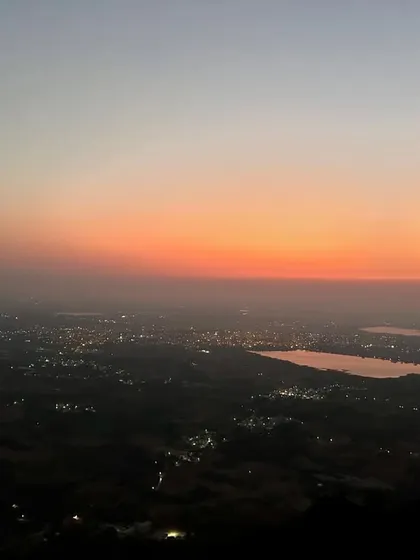 The sky painted in hues of orange and pink during sunrise at Skandagiri. A truly magical sight that makes the early morning start worthwhile.