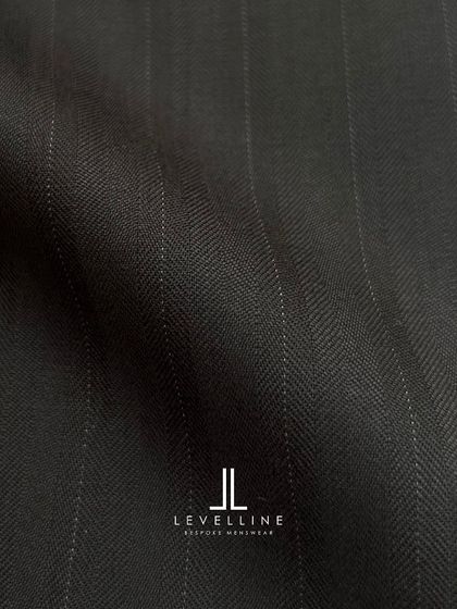 A dark charcoal pinstripe with a subtle herringbone weave, adding a layer of texture and sophistication.