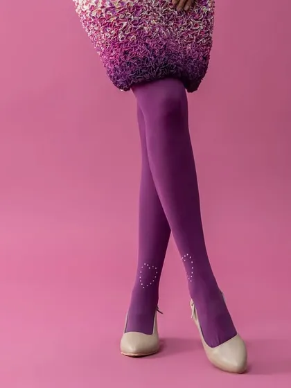 A detail-oriented shot focusing on the lower half of an avant-garde look. The vibrant purple tights with delicate ankle details, paired with classic pumps, highlight my belief that every element of an outfit contributes to the overall narrative.