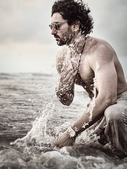 An action shot from the beach session. The splash of water adds a dynamic and raw element, creating a memorable and dramatic image.
