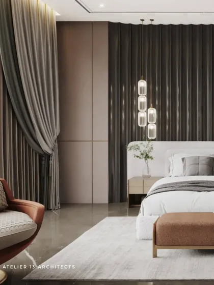 This bedroom design uses a dark, fluted panel feature wall behind the bed to create a dramatic and moody atmosphere. The deep tones of the wall contrast beautifully with the light-colored bed and soft rug.