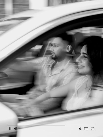 Capturing the feeling of a drive through the city, this motion-blur shot in black and white creates a dynamic and cinematic memory of their journey together.