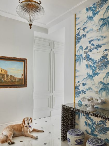 In the foyer of this 76th-floor Mumbai home, a serene, hand-painted wallpaper sets a tone of timeless elegance. Paired with a bone-inlay console and vintage lighting, it creates a welcoming entrance that is both luxurious and artful.
