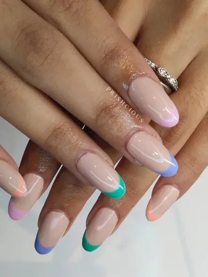 Colorful pastel French tips are perfect for spring and summer. Each nail has a different soft pastel color, creating a fun and playful rainbow effect.