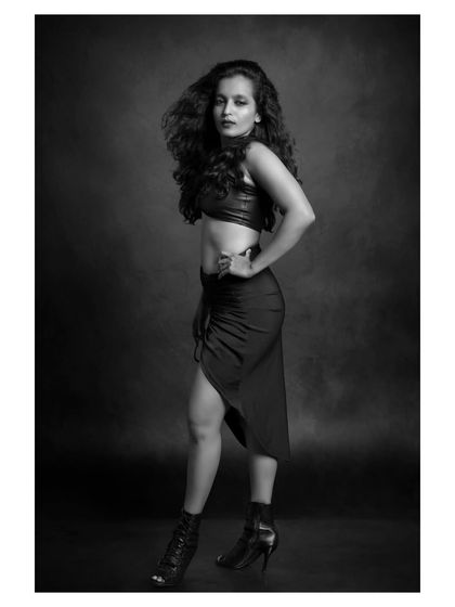 A black and white portrait of a dancer with beautiful, flowing hair. The image captures a sense of movement and freedom.