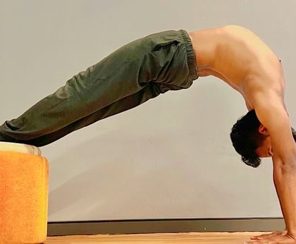Using a prop to deepen a backbend. This variation of Purvottanasana, or upward plank pose, provides an intense stretch for the shoulders, chest, and front of the body.