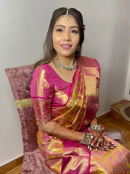 A beautiful portrait of the bride-to-be in her pink Kanjeevaram saree. The makeup is soft and glowing.