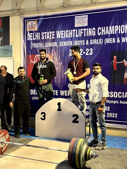 Standing on the podium with the winners. My role as an official is to support the athletes and celebrate their achievements on the platform.