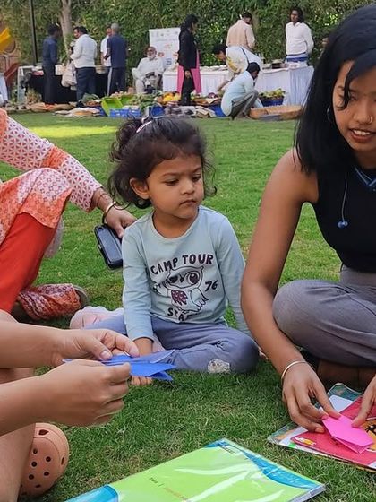 Young learners engaged in a paper craft activity at the Kids Kona. We encourage children to share their skills and learn from each other in a supportive and creative environment.