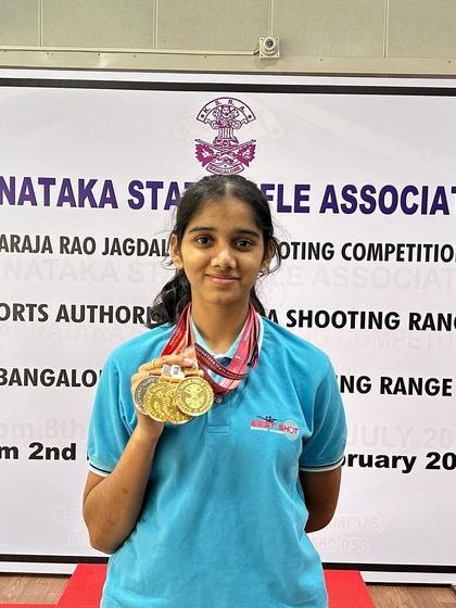 Anushka with her impressive collection of medals from the 1st Nagaraja Jagdale Shooting Competition, where she dominated the Air Rifle events.
