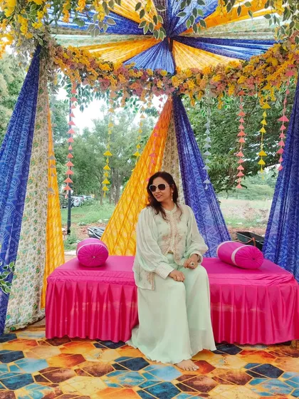 Taking a moment to relax on the colorful stage setup before the guests arrive. The Rajasthani-themed decor was stunning.