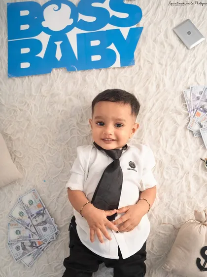 A top-down view of our little executive with his briefcase and money. This angle provides a unique and creative perspective for his portrait.