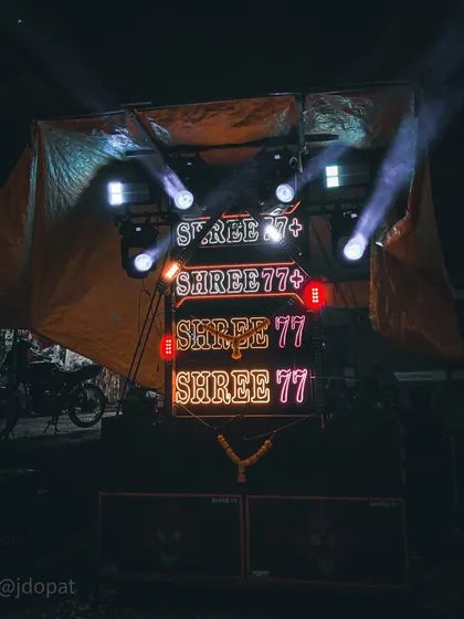 A mobile sound system with neon signs and spotlights, typical of the loud and vibrant Narakasura processions in Goa.