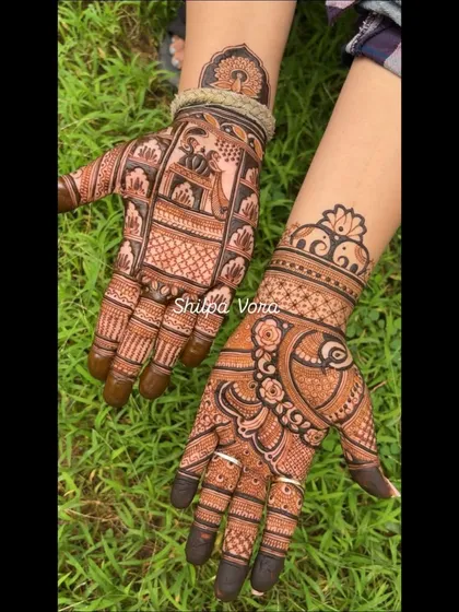 A mix of traditional motifs, with a doli scene on one hand and a peacock design on the other.