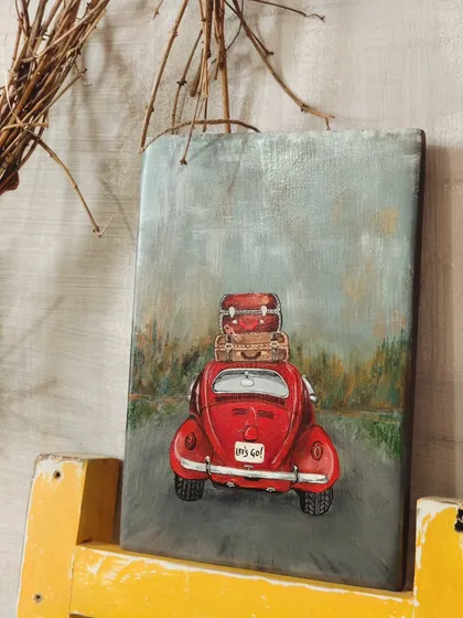 Our "Wanderlust on Wood" painting, styled in a rustic setting. The vintage red car is ready for the open road, inspiring a sense of freedom and adventure.