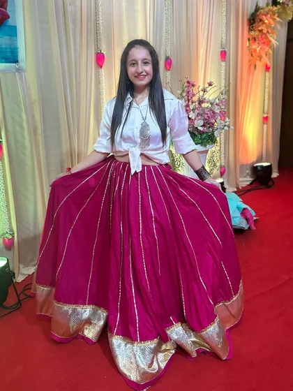 A happy moment in my pink and white Indo-Western outfit at a Chaitra Navratri event.