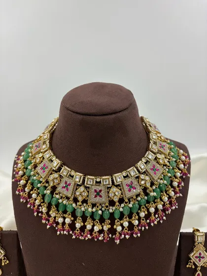 My Divya premium antique gold necklace set, featuring colorful meenakari work in pink and green on a unique square-shaped design.