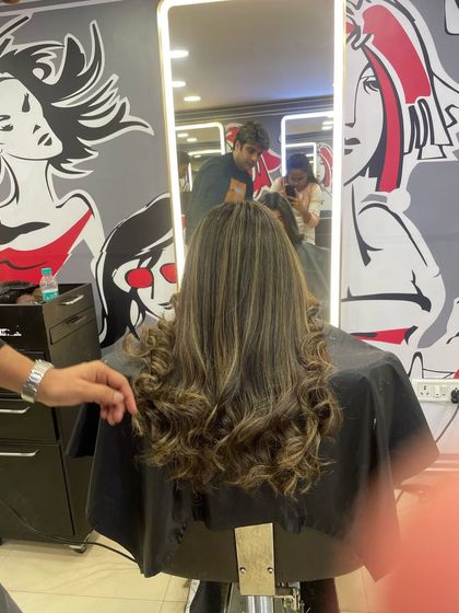 A behind the scenes look at a styling session. Here, I'm just finishing up a client's hair, adding some final touches to her fresh color and curls.