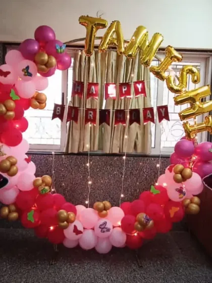 This butterfly-themed balloon ring for Tanish's birthday was set up against a window. The fairy lights woven into the balloons add a magical sparkle, especially for an evening celebration at home.