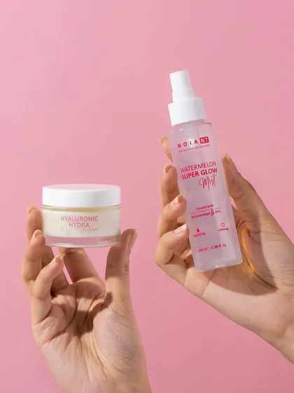 A simple and relatable hand model shot. Holding the two products together shows how they can be used as part of a routine, while the clean pink background keeps the image bright and on-brand.