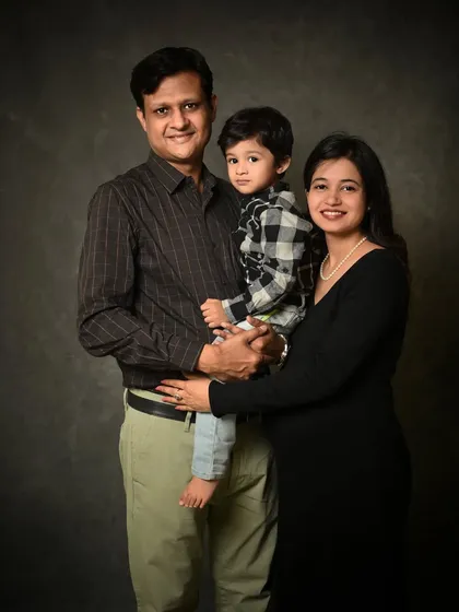 A formal family portrait against a classic painted backdrop. This style is perfect for creating a timeless piece of art for your home that captures your family at this moment in time.