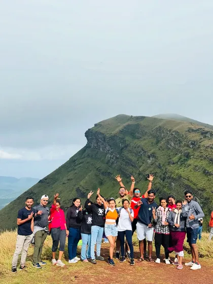 A cheerful group posing with the iconic Z-point peak in the background. This is a popular spot on my Chikmagalur exploration trips.