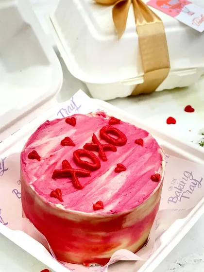 A fun and flirty "XOXO" bento cake with pink watercolor frosting. Perfect for Valentine's Day or just to send some love.