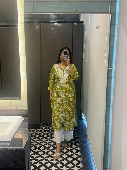 A simple and elegant green chikankari kurta with white pants. This is a classic and comfortable choice for a summer day at the office.