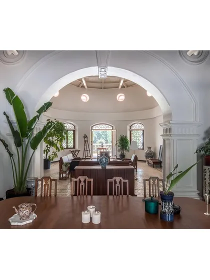 A view from the dining area into the main hall, framed by a grand restored archway. This image showcases our approach to adaptive reuse, where we reconfigure interior spaces for modern functionality while highlighting original architectural features.