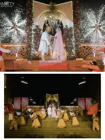 A spectacular varmala moment at a grand night ceremony in Chennai. The stage is lit with fireworks as dancers celebrate the couple's union, creating a truly cinematic and unforgettable scene.