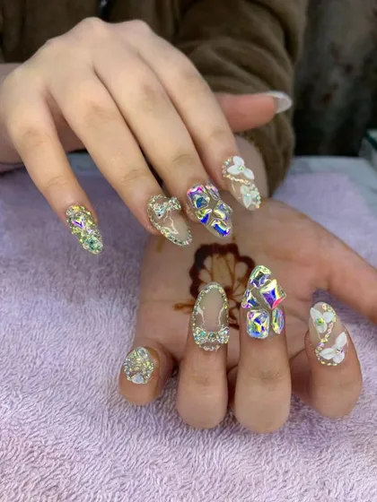 An opulent and glamorous set featuring a mix of 3D sculpted flowers, bows, and an abundance of iridescent crystals. This design is perfect for anyone wanting maximum sparkle and dimension.
