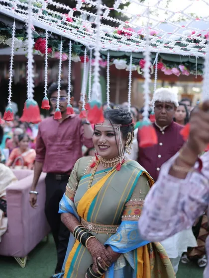 A candid shot of the bride during her entrance. Her makeup is glowing, and her smile is infectious.