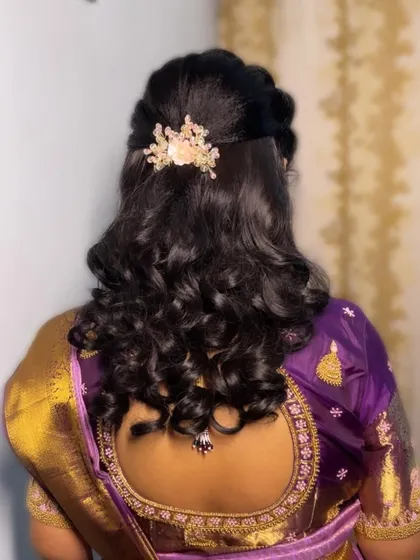 A half-up, half-down hairstyle with soft curls. This is a versatile and popular choice for receptions and parties, adorned with a delicate hair clip.