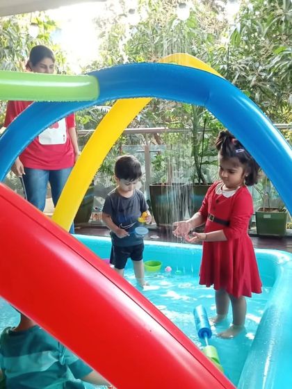 A glimpse of our Holi week fun, where even the littlest ones can enjoy the water play under our rainbow sprinkler.