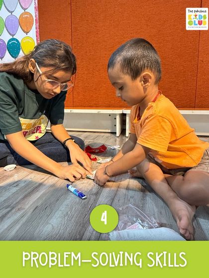 Here, a child learns to think critically and solve problems. This image captures a moment of focus as a mentor guides a young learner, building essential problem-solving skills through a hands-on activity.