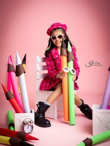 Cool and confident, the birthday girl poses with her giant colorful pencils. I provide fun accessories like these quirky sunglasses to match the theme.