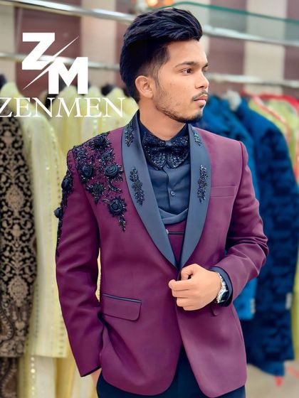 A confident pose in the wine tuxedo with black floral details. The grey lapel adds another layer of visual interest to this unique piece.