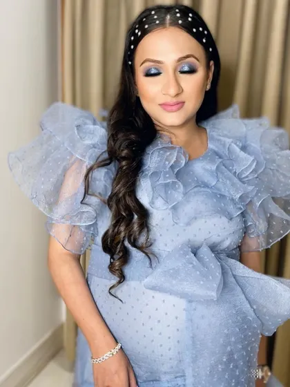 A close-up showing the pregnancy glow, enhanced with a flawless base and soft pink lips.