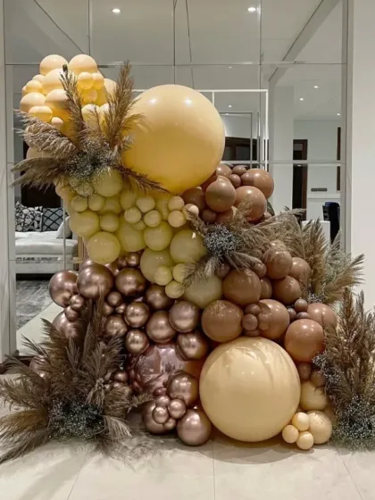 A luxurious balloon installation in earthy and metallic tones, demonstrating how I can create a high-impact decor piece even in a smaller space.