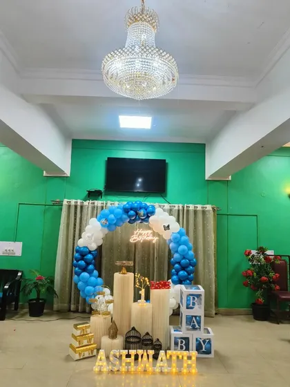 A wider shot showing how the blue and white birthday balloon setup can transform a living room space for a memorable home celebration.
