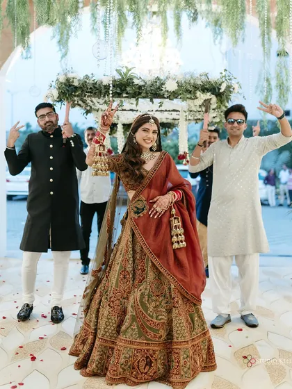 The bride's grand entry under a 'phoolon ki chadar', with her brothers striking a fun pose.