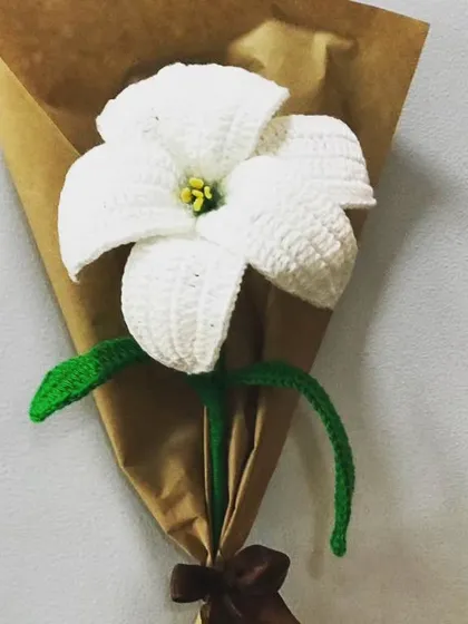 A classic white lily, handcrafted to capture its natural elegance. This piece is perfect for creating a clean, timeless look in your home decor or as part of a custom wedding bouquet.