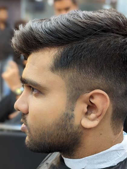 A close-up profile of a fresh haircut. Note the clean lines of the fade and the textured volume on top, a popular and versatile style for men.