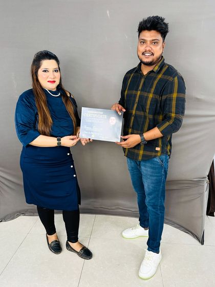 Celebrating another student's achievement. She is now fully equipped with professional hairstyling skills.