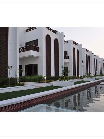 These exquisite townhouses in Muscat each feature a private rooftop deck and are organized around a central water feature. The design provides a luxurious and serene living environment for large families.